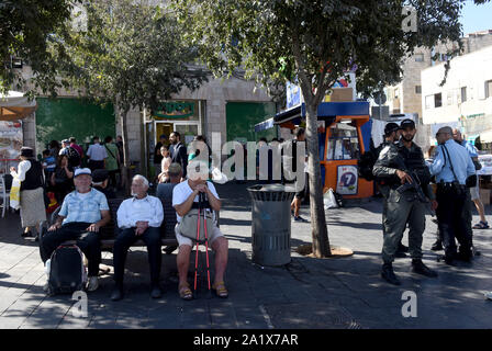 Jérusalem, Israël. Sep 29, 2019. La police des frontières israélienne se trouve près de vieux hommes assis sur un banc à l'extérieur du marché Mahane Yehuda avant Roch Hachana, le Nouvel An juif, à Jérusalem, le dimanche, 29 Septembre, 2019. Roch hachana est une maison de vacances de deux jours qui commence au coucher du soleil aujourd'hui, et est le début de la haute jours fériés. Assister les juifs synagogue où le shofar est soufflé un 100 fois le réveil de se repentir. Photo par Debbie Hill/UPI UPI : Crédit/Alamy Live News Banque D'Images