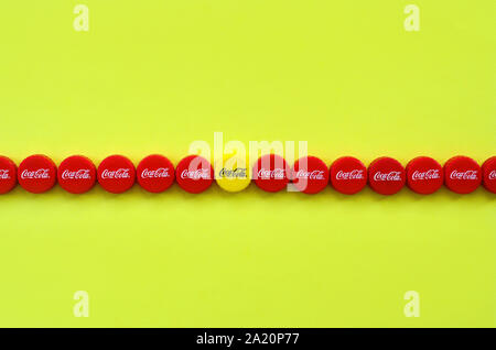 KHARKOV, UKRAINE - 8 septembre 2019 : de nombreux red caps avec coca cola logo sur fond jaune. Le Coca-Cola est une boisson sans alcool célèbre d Banque D'Images