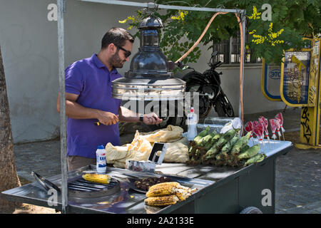 Athènes, Grèce, Juin 04, 2016. Un vendeur de rue de maïs est en attente d'acquéreurs d'arriver. Banque D'Images