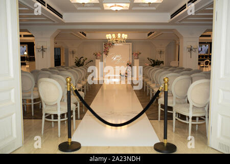 Salle de mariage. Des rangées de chaises blanches pour les clients. de fête Arche de mariage pour la mariée et le marié Banque D'Images