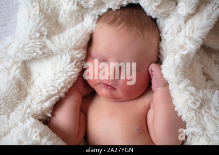 Un beau bébé nouveau-né de dormir dans une couverture de fourrure Banque D'Images