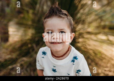 Close up portrait of young cute toddler boy smiling