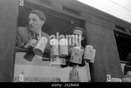 La photo montre probablement membres de l'expédition dans l'Himalaya à la large pic entre août et décembre 1954. Le voyage pour la région himalayenne explique le jour de départ le 28 avril. Les alpinistes participantes disent au revoir à leurs proches et les parties intéressées à la gare principale de Munich. Les participants à obtenir dans le train équipé de verres. Banque D'Images