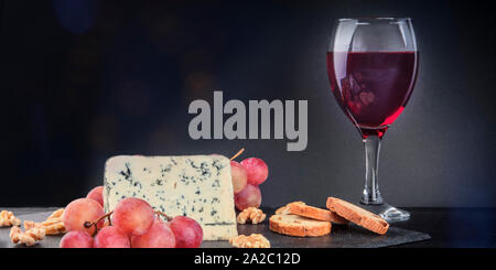 Un panorama de fromage gorgonzola avec vin rouge sur un fond sombre avec copie espace Banque D'Images