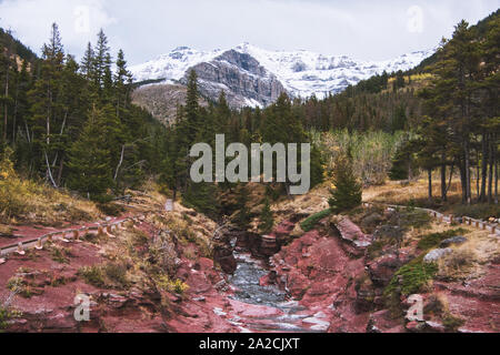 Vue sur le Red Rock Canyon dans le parc national des Lacs-Waterton du pont traversant la rivière sur un jour nuageux Banque D'Images