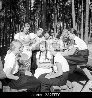 Eine BDM Mädelschaft sitzt dans der Sonne im Freizeitlager am Werbellinsee Altenhof, Brandebourg, 1930er Jahre. Un groupe de filles BDM assis dans le soleil au camp de loisirs du Deutsche Arbeitsfront à Altenhof, Brandebourg, 1930. Banque D'Images