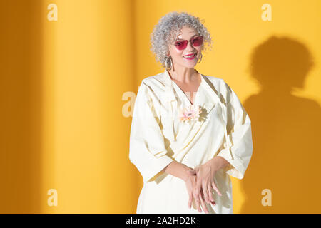 Curly élégante femme portant des lunettes lumineuses se sentir heureux Banque D'Images