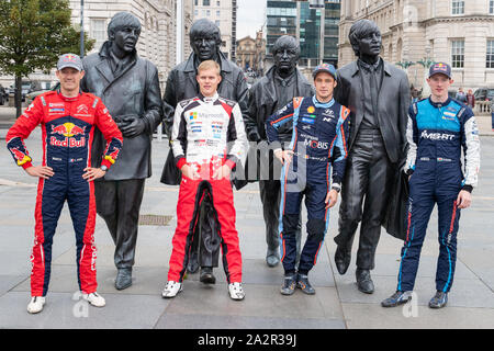 Liverpool, Royaume-Uni. 3e oct, 2019. (L), Sébastien Ogier, Ott Tänak, Thierry Neuville & Elfyn Evans poser pour des photos en face de la populaire, des statues en bronze des quatre Beatles créé par le sculpteur Andy Edwards au Pier Head, avant le début de la Wales Rally GB, Crédit : Jason Richardson/Alamy Live News Banque D'Images