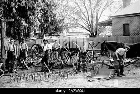 - Négatif de forgeron et de mettre en Œuvre des politiques', Wangaratta, Victoria, vers 1915, un groupe de 5 tradsemen avec une exposition de leurs produits. Les produits présentés : sillon mono et multi-Charrues à versoir en zig-zag, herses, un scoop de la terre ferme, voyage itinérant en charrettes et astuce drays, l'eau ou une mangeoire et de fers. Quatre des hommes portent des tabliers de forgeron en cuir et deux marteaux de forgeron holding, tandis que l'homme de droite est en train de ferrer un cheval Banque D'Images