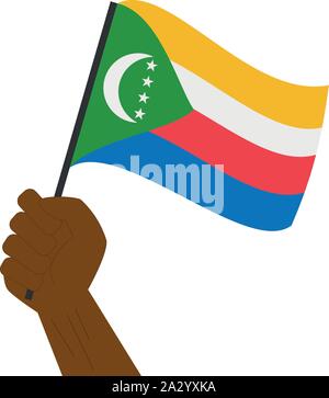 Main tenant et élever le drapeau national des Comores Illustration de Vecteur