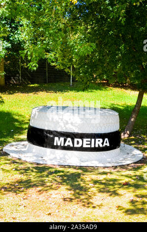 Santana, Madeira, Portugal - Sep 24, 2019 : grand chapeau de paille dans la région de Green Park. Panneau blanc Madère sur champ noir sur un chapeau. Chapeau de paille traditionnel de Madère. Souvenir typique de l'île portugaise. Banque D'Images