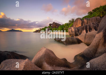 Les rochers de granit au coucher du soleil une lumière douce à l'Anse Source d'argent beach, l'île de La Digue, Seychelles Banque D'Images