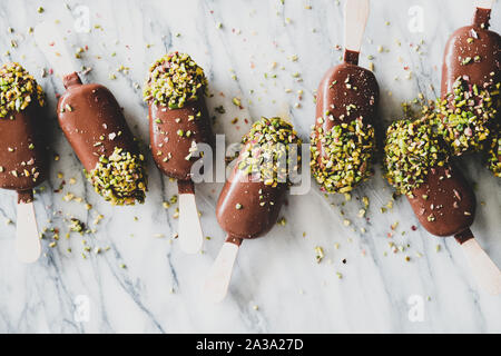 La crème glacée Chocolat glacé à la pistache pop sur fond de marbre Banque D'Images