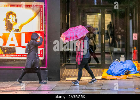 Preston, Lancashire. 7 octobre 2019. Météo britannique. Des traverses rugueuses dans la porte de magasin un humide, froid, brustier de commencer la journée dans le centre-ville de Preston. Les gens qui passent le mendiant, les sans-abri et les sans-abri, les gens qui vivent dans la rue, la porte, le sommeil, la pauvreté, le chômage, le bien-être, les mendiants, le tramp, la dérive, le shabby, le tagged, le vagabond, le malheur, le, le mauvais agité, le malheur, le, le sommeil, le peu agité, le malheur. Banque D'Images