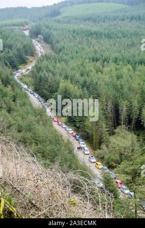 Ligne,lignes,de,Spectateurs Spectateurs,voitures,garé,jusqu,en,single,fichier,serpent,à travers la forêt,Welsh hills,Myherin,World Rally Championship, WRC Rallye automobile GO au Pays de Galles,Welsh,UK, Banque D'Images