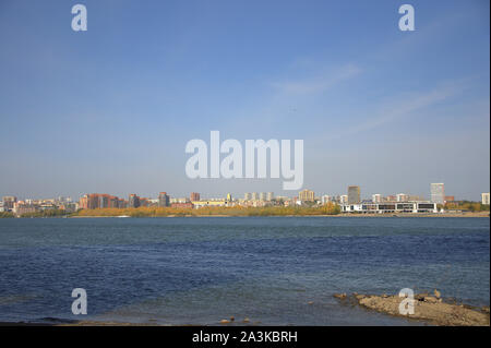 Paysage de ville, immeubles de grande hauteur sur les rives de la rivière d'automne sous un ciel clair. Novosibirsk, Russie. Banque D'Images