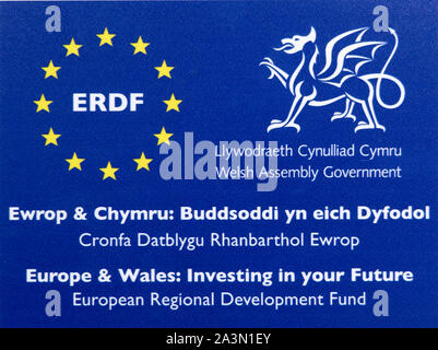 Affiche bilingue FEDER Fonds Européen de Développement Régional Welsh Assembly Government avis à une propriété bénéficiaire au Pays de Galles UK Banque D'Images