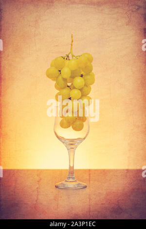 Idée conceptuelle de raisins dans le verre de vin comme matières premières au lieu de produit final à l'aide du filtre rétro Banque D'Images
