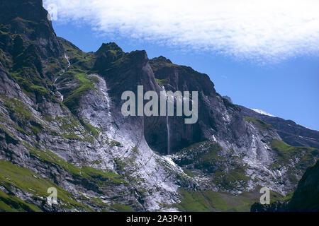 Cascade pittoresque sur la crête des Alpes. Rocky Alpes avec de beaux paysages. Paysage de haute montagne, nuage blanc sur bleu ciel. Grindelwald, Suisse. Banque D'Images