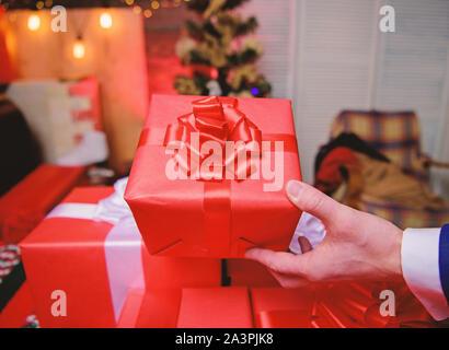 Cadeaux concept. Moments magiques. Préparer des cadeaux surprises pour la famille et les amis. Se préparer à Noël et nouvel an. Boîtes cadeaux avec big ribbon bow close up. Les cadeaux emballés rouge ou présente. Banque D'Images