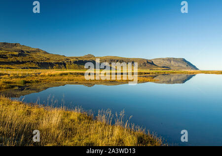 Lac côtier près d'Olafsvik sur la péninsule de Snaefellsness Ouest de l'Islande. Son calme permet des réflexions claires et belles. Banque D'Images