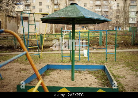 Le sandbox enfants avec un parapluie en bois dans le pays de la maternelle. Banque D'Images