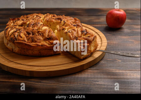 Apple pie de Cornouailles avec un morceau sur l'omoplate Vue de dessus sur fond marron style rustique. Copie de l'espace pour votre texte Banque D'Images