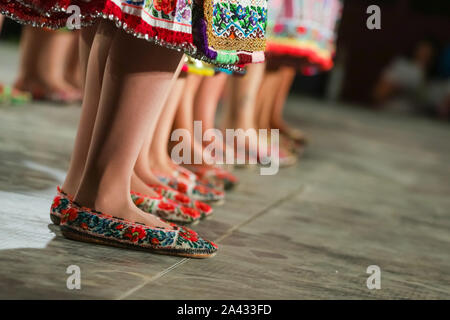 Close up de jambes de jeunes danseuses roumains en costume folklorique traditionnel. Le folklore de Roumanie Banque D'Images