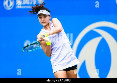 Xinyu Wang de Chine récupère la balle contre Kurumi Nara du Japon à la match de qualification des femmes simple de 2019 WTA Open de Wuhan à Wuhan, 100 Banque D'Images