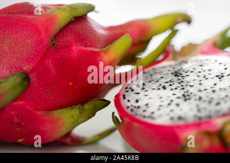 Fruit du dragon. Fruit du dragon animé sur fond blanc. Fruit du dragon blanc tranché ou pitaya sur plaque blanche sur la table, close-up. Exotiques et tropicaux Banque D'Images