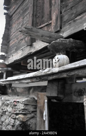 Atmosphère mystérieuse sur l'image d'une maison en bois construite sur des fondations en pierre divisée par des poutres sous lequel on peut voir un sourire lointain pumpkin Banque D'Images