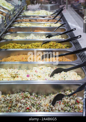 Vue latérale des bacs de différents types de salades à un bar à salades dans un supermarché Banque D'Images