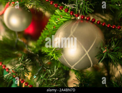 Bal de Noël d'argent à un arbre artificiel avec du rouge et sphérique, décorations avec des paillettes, vert, rouge et des tons d'argent Banque D'Images