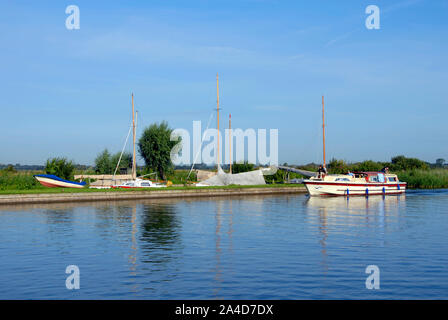 Tôt le matin, les vacanciers sur river cruiser tranquille sur le tronçon de rivière Thurne, Norfolk, Angleterre. Banque D'Images