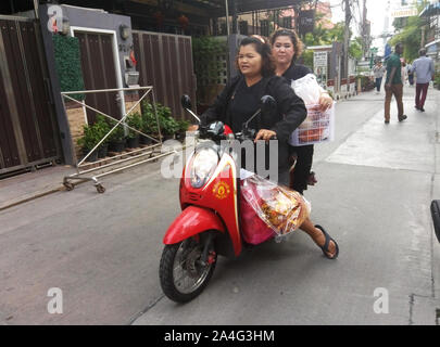 Deux femmes thaïlandaises porter la nourriture sur une moto. Banque D'Images