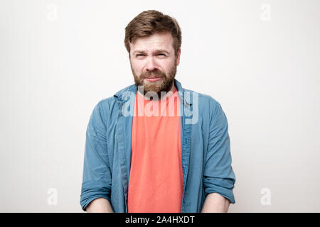 L'expression du visage drôle de ressentiment d'un homme qui est sur le point de pleurer. Des sentiments, des émotions négatives. Isolé sur fond blanc. Banque D'Images