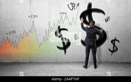 Les hommes d'arrière-plan du graphique profit colorés plaçant les mains sur un mur peint en noir avec le signe dollar et imprime à la main. Banque D'Images