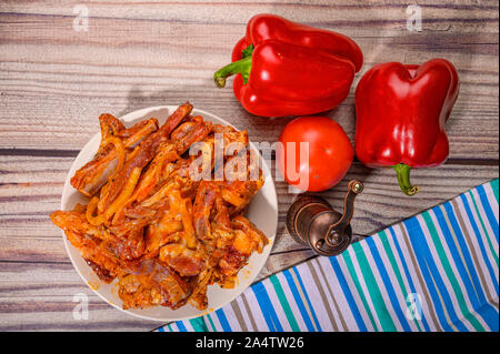 Côtes d'agneau mariné aux épices dans une assiette sur la table. Avec des tomates et poivrons doux Banque D'Images