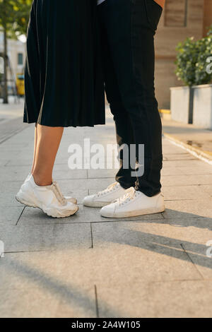 Les filles se dresse sur la pointe des pieds pour embrasser son homme - Close up sur les chaussures Banque D'Images