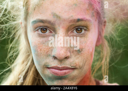 Caucasian girl couvert de poudre de couleur après couleur run Banque D'Images