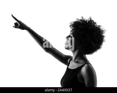 Un jeune adolescent africains mixed race girl woman pointing silhouette ombre en studio isolé sur fond blanc Banque D'Images