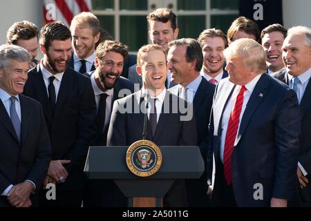 Président américain Donald Trump, droit, regarde St Louis Blues player Jaden Schwartz prononce une allocution lors d'une cérémonie d'accueil de la Coupe Stanley 2019 l'équipe professionnelle de hockey sur glace, les Blues de Saint-Louis, dans la roseraie de la Maison Blanche le 15 octobre 2019 à Washington, DC. Banque D'Images