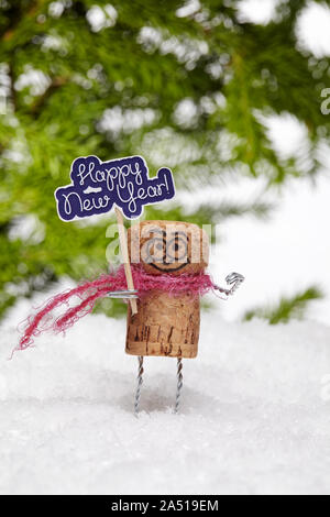 Drôle de bouchon de champagne sur l'homme blanc de la neige n'importe qui souhaite 'bonne année'. La composition du nouvel an avec les jouets. Banque D'Images