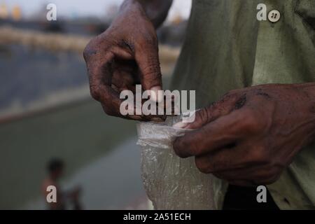Dhaka, Bangladesh. 17 Oct, 2019. Un travailleur compter jetons après avoir déchargé le charbon provenant d'un navire près d'une rivière dans la périphérie de Dacca. Credit : MD Mehedi Hasan/ZUMA/Alamy Fil Live News Banque D'Images