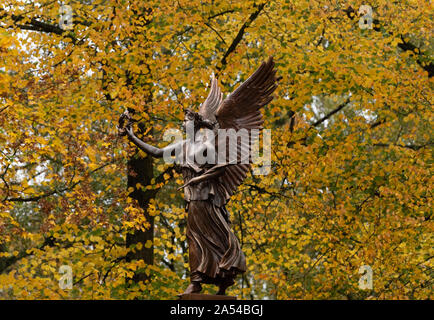 16 octobre 2019, le Brandebourg, Bernau : la déesse de la victoire sur son piédestal Viktoria se trouve en face d'arbres du parc de la ville. Le mémorial de la figure ailée avec Victor's Wreath est érigée près de la muraille de la ville en 1890 selon les plans du sculpteur Friedrich Thiele. Le socle porte l'inscription 'leurs braves guerriers de la glorieuse campagne de 1864, 1866 et 1870/71. En reconnaissant la reconnaissance. La ville de Bad'. Elle commémore l'honneur des soldats de la frontière germano-danoise, Prussian-Austrian et guerres franco-allemand. Photo : Soeren Stache/dpa-Zentralbild/ZB Banque D'Images