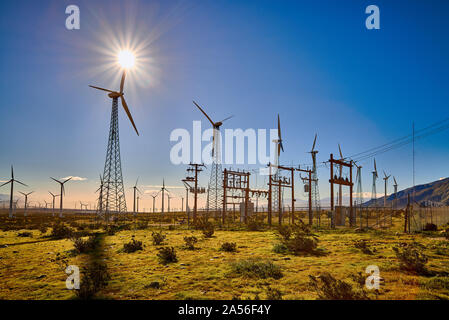 Les moulins à vent qui se profile avec un soleil éclatant dans un ciel bleu. Banque D'Images