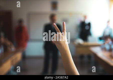 Profondeur de champ libre avec un élève a soulevé la main pour répondre ou poser une question ou de faire du bénévolat pour une tâche dans la salle de classe. Banque D'Images