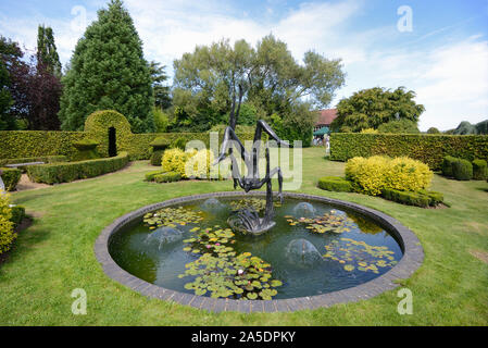 Étang ornemental ronde & Statue de Icarus au jardin de Heroes & Villains Dorsington Stratford-upon-Avon en Angleterre Banque D'Images