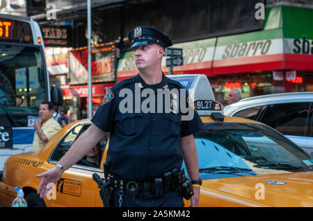 Un policier dirige le trafic près de Times Square. 1560 Broadway, entre les 46e et 47e Rue . Téléphone 212-869-5667 (8:00 à 20:00) . Près de 35 mi Banque D'Images