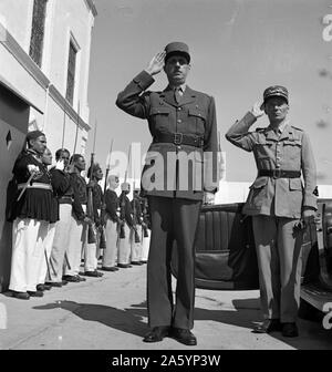 Carthage, Tunisie. Le général de Gaulle, accompagné du Général Mast, saluant comme le groupe joue Marseillaise à l'extérieur du palais d'été du bey de Tunis, en Tunisie en 1943 , faisant la seconde guerre mondiale Banque D'Images